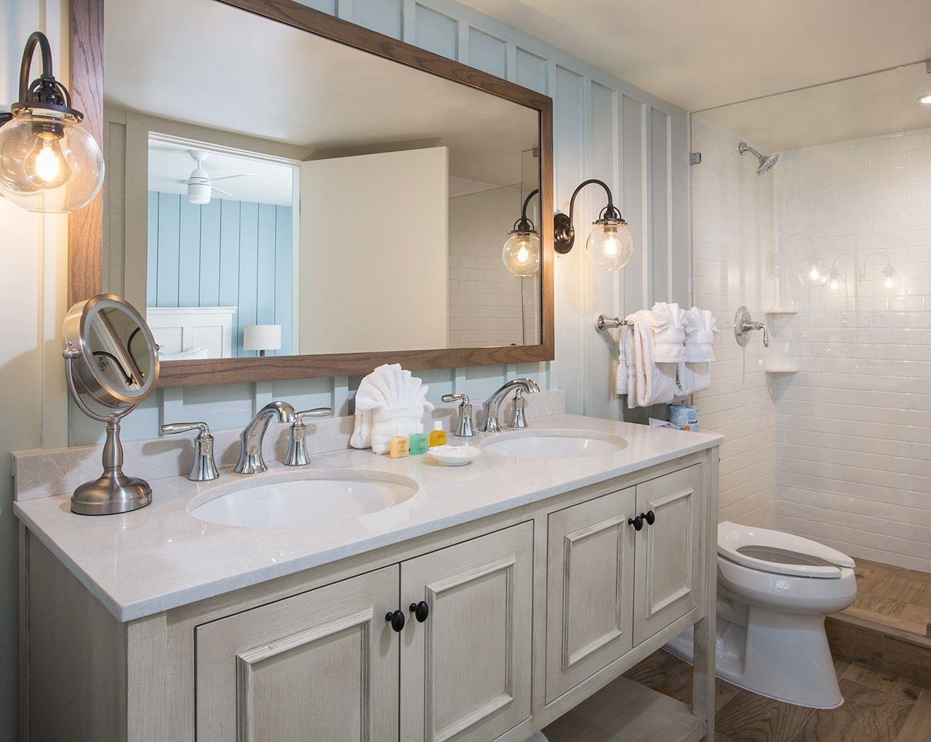 Hotel bathroom with engineered stone shower surround and double vanity