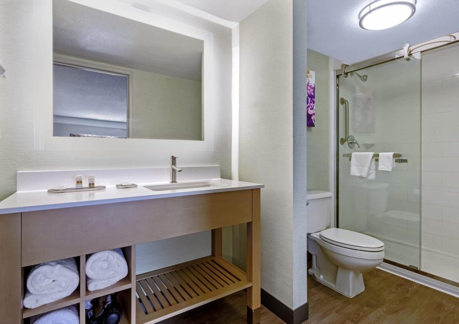 Hotel bathroom with glass shower door