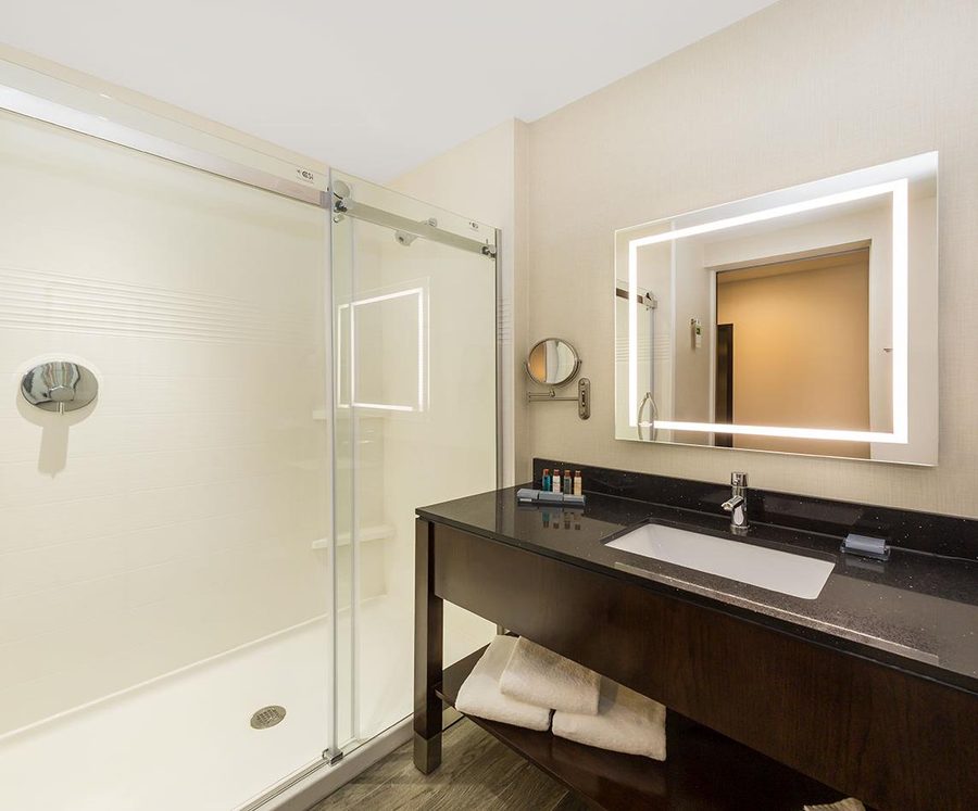 Modern hotel vanity with backlit mirror