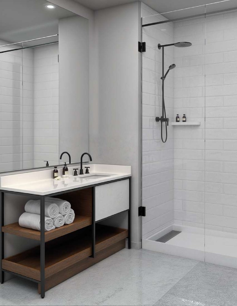 Walk-in shower with cultured marble surround and glass door